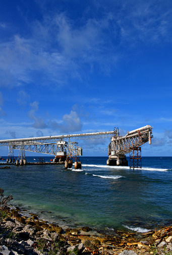 A phosphate-loading cantilever extending over the reef to a ship