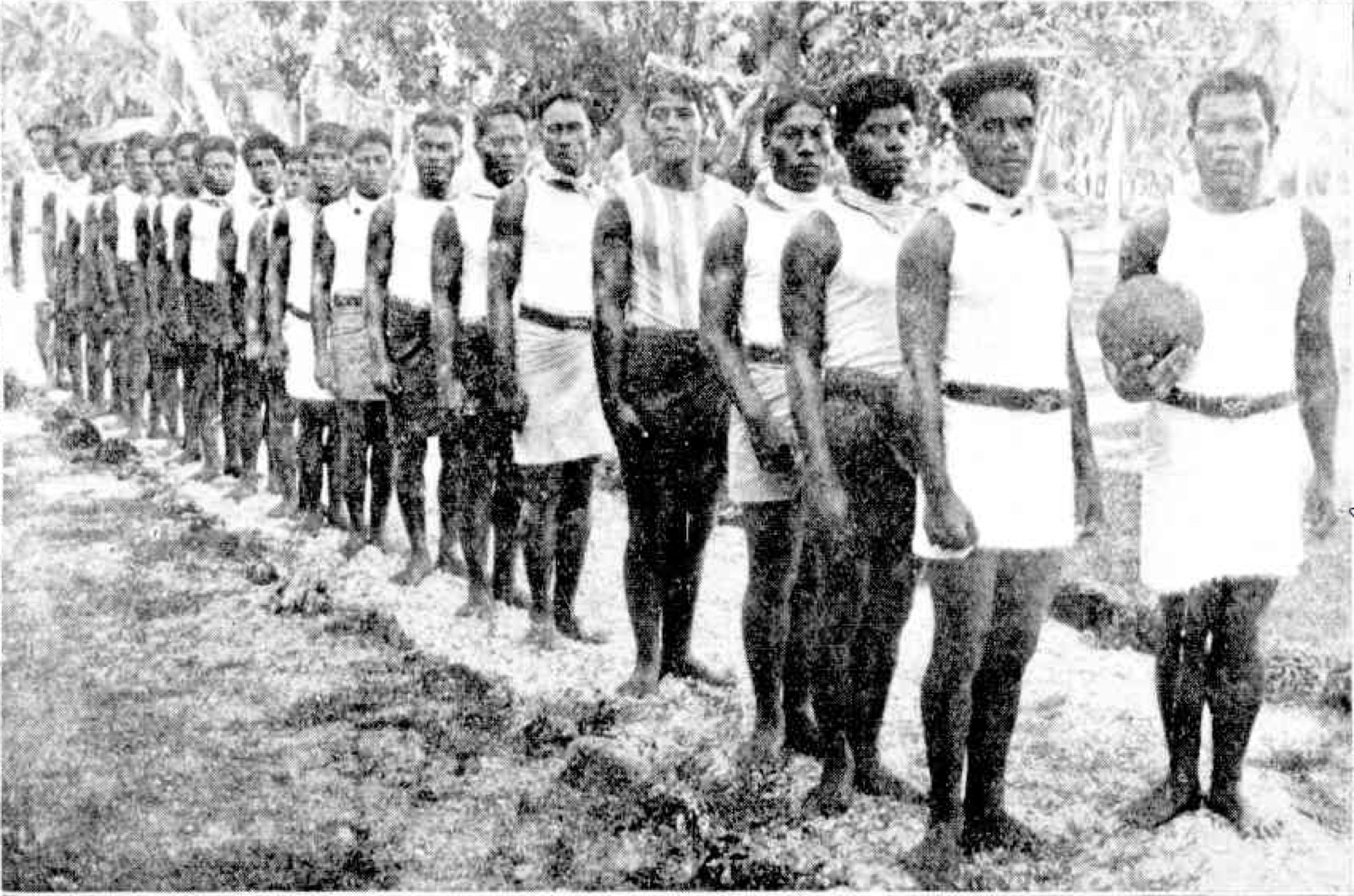 A Nauruan police football team lined up in sleeveless guernseys, 1919